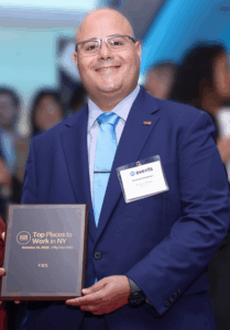 Samuel Andrews, PE, accepting the Top Places to Work in New York Award on behalf of VRX